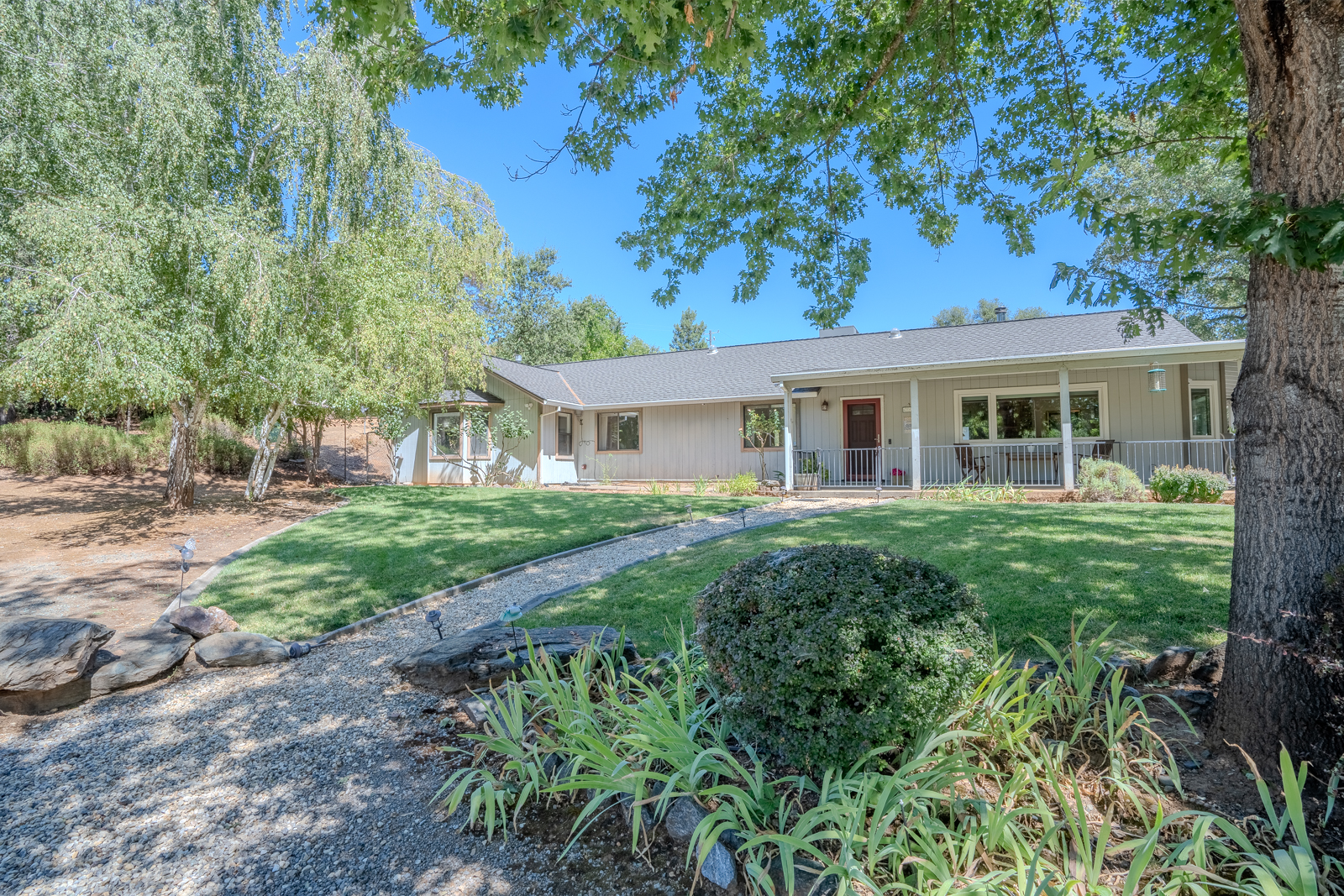 Exterior front view of home with mature landscaping